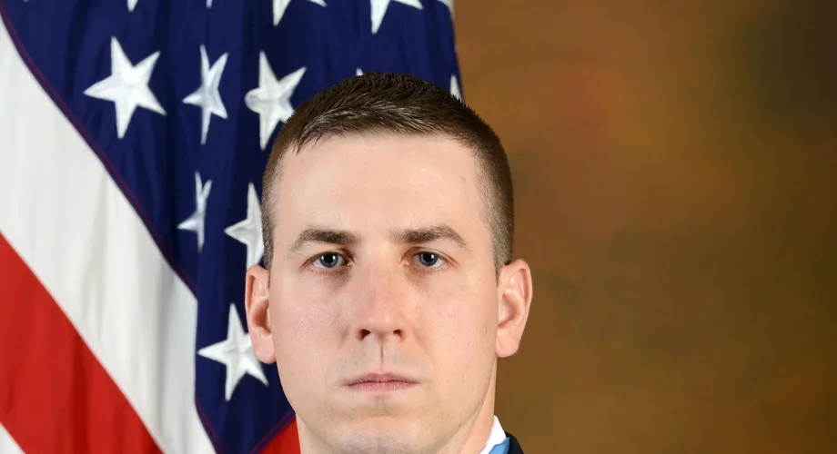 Official U.S. Army portrait of Staff Sergeant Ryan M. Pitts, Medal of Honor recipient, in dress uniform with the American flag