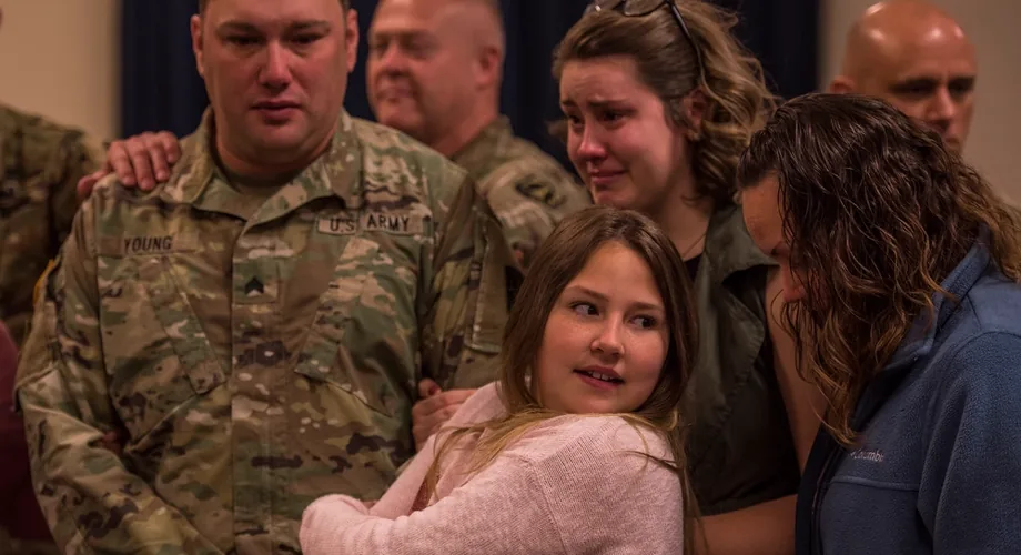 A U.S. Army soldier saying goodbye to his family before a separation from home.