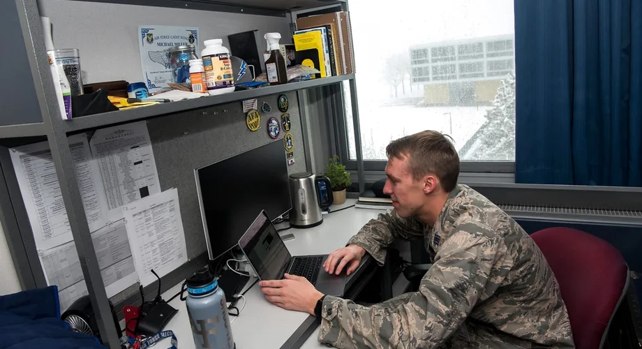 U.S. Air Force airman checking military pay information on a laptop at his desk
